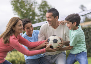 A family plays soccer together.