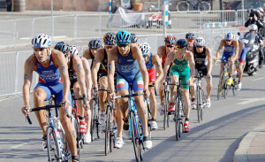 A group of athletes race each other in a triathlon.