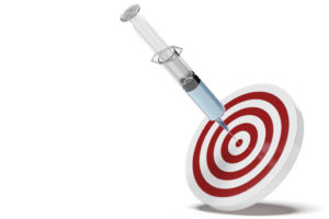 A vaccine's injection needle is placed in a bullseye.