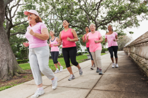 A group of women jog together outside.