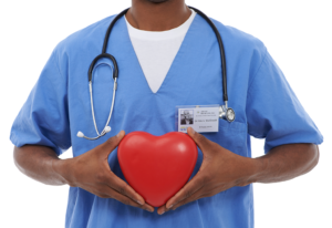 A medical professional holds a heart-shaped object.