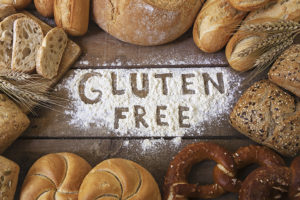 Bread surrounds a pile of flour. "Gluten Free" is written inside the flour.