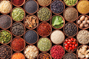 More than twenty bowls of herbs and spices are shown.