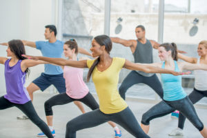 A group of people participate in yoga together.