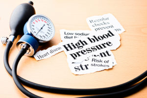 Snippets of paper are shown. One reads, "High blood pressure." Another reads, "Risk of strokes." 