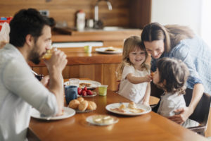 Picture of a young happy family having breakfast together