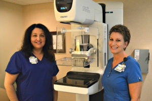Maria Frendo and Lisa Soueidan at Betty Ford Breast Care Services at Spectrum Health Gerber Memorial, poses for a photo with a 3-D mammography device.