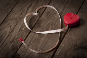 Measuring tape is shown formed into a heart shape.