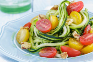 Zucchini pasta with tomatoes is shown.