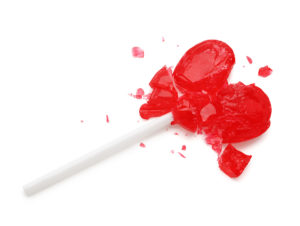 A red, heart-shaped sucker is cracked open.