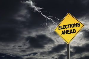 A stormy sky with lightning is shown behind a yellow sign saying, "Elections Ahead."
