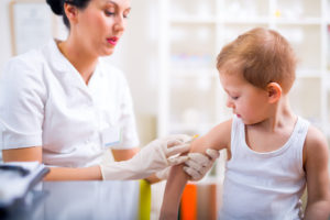 A young boy gets a vaccine at his doctor's visit.