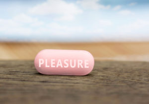 A pink pills is shown that says, "Pleasure."