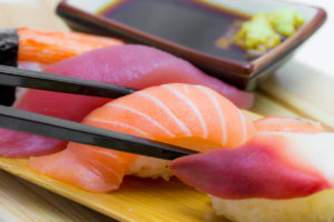 Sushi with salmon is in focus.