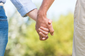Two people are holding hands.