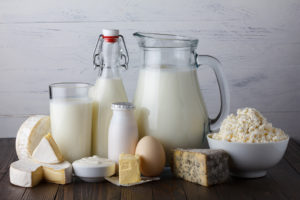 Dairy products such as, milk, eggs and cheese are in focus.