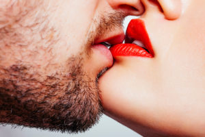 A man kisses a woman's lips.
