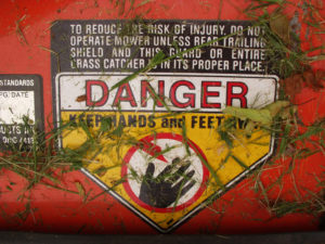 A sign reads, "DANGER. KEEP HANDS AND FEET AWAY."