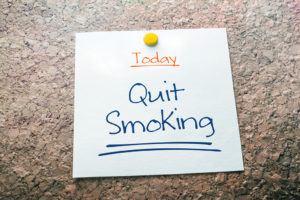 A piece of paper reads, "Today. Quit Smoking."