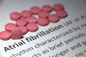 Text that reads, Atrial fibrillation, is shown next to pills.