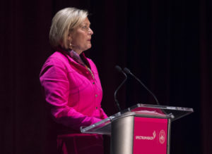 Susan Ford Bales is shown standing at a podium.