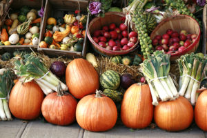 Pumpkins, root vegetables and other fall fare are in focus.