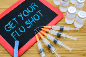 A chalkboard reads, "Get your flu shot." 