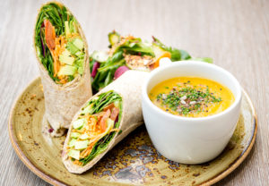 A vegetarian wrap and soup are shown.