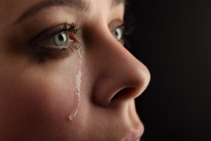 A woman shedding a tear.