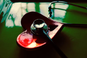 A stethoscope lies in a heart-shaped smoking dish.
