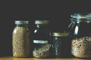 A pantry shelf holds whole grains in Mason Jars.