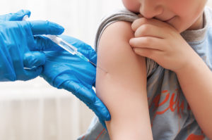 A kid gets a vaccine.