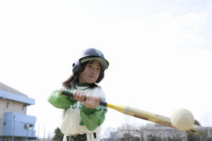 A young kid plays baseball.