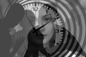 A person is displayed in the background of a clock.