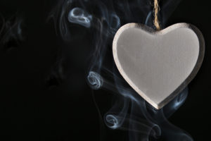 A heart-shaped object is surrounded by smoke.