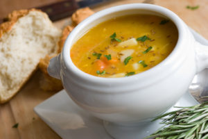 A bowl of soup is in focus.