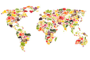 A map of six continents is in focus. The continents are made out of food.