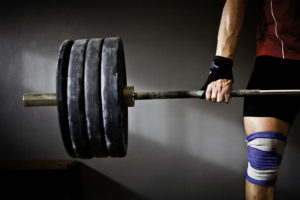 A person deadlifts a significant amount of weight.