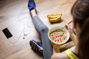 A person appears to be eating cereal before she goes on a run.