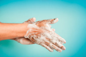 A person is washing their hands with soap.