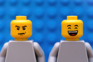 Two lego characters are shown. One lego character is frowing, the other lego character is smiling big.