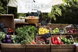 A Farmers market with fresh fruits and vegetables is shown.