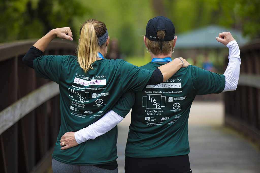 Angie Howard, left, and Pam Marvel show their support for friend Cassie Smith, who was diagnosed with Stage 3 breast cancer six weeks ago. The women ran the 10K at the Wheatlake Festival of Races. (Justin McKee | Spectrum Health Beat)