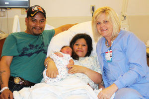 Michele Schoon, RN, poses with Elena Santiz-Collazo, Antonio Jauregui and their newborn son, Jonathan. 
