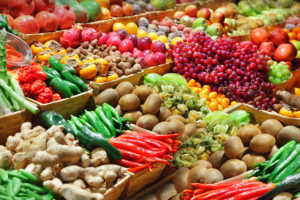 Large bins of fruits and vegetables are shown.