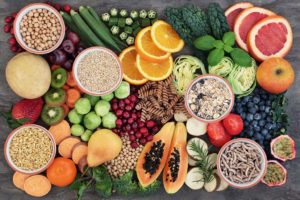 Fruits, vegetables, and a variety of nuts are shown.
