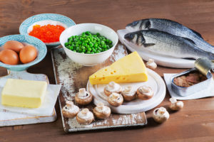 Foods with vitamin D are shown; including fish, peas, cheese, mushrooms, eggs and butter.
