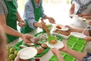 A group of volunteers serve food at a community event. 