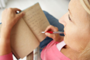 A woman writes in her journal.