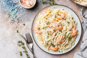 A pasta dish is shown with shrimp.